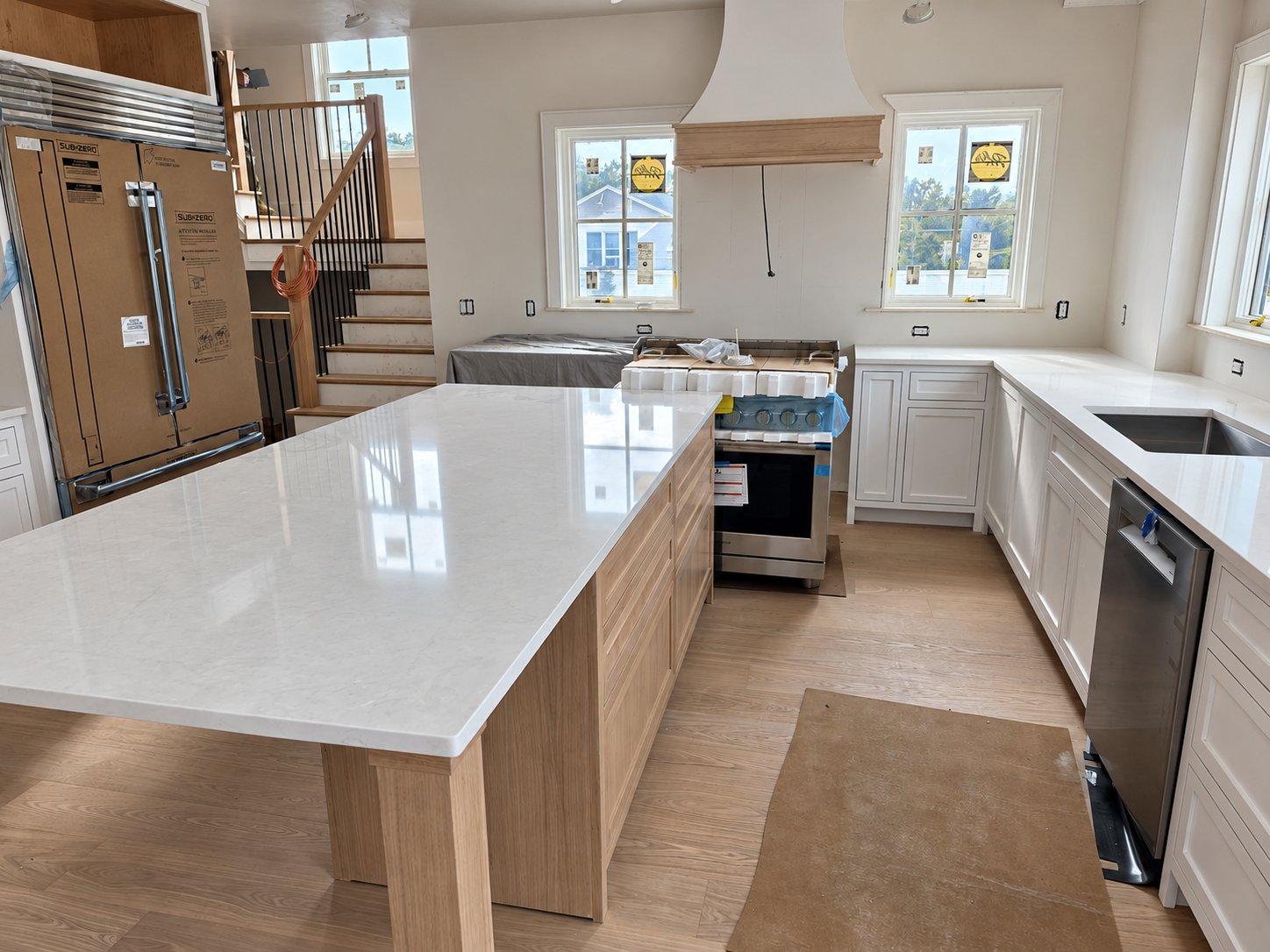 93 Barker Rd, Scituate. Kitchen under construction with a white oak island, quartz counters, and inset cabinetry.